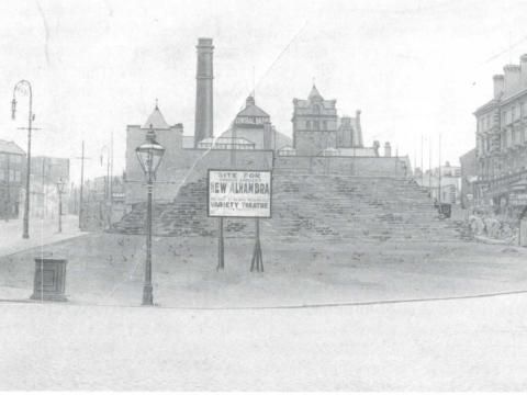 A black and white sketch of Morley Street Waste in Bradford with a sign for the Alhambra Theatre being built.